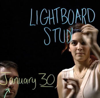 An instructor records in the Lightboard studio. 